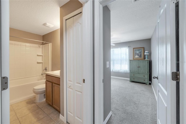 full bathroom featuring shower / bathing tub combination, tile patterned flooring, toilet, and a textured ceiling