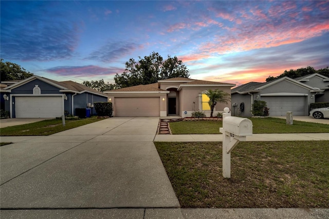 ranch-style house with a lawn and a garage