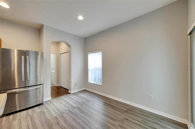 kitchen featuring stainless steel fridge and light wood-type flooring