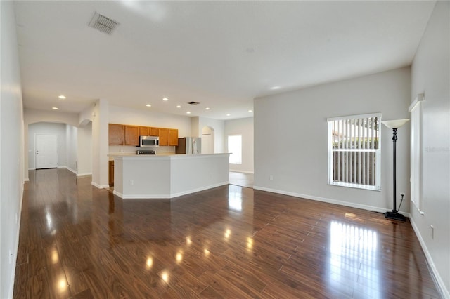 unfurnished living room featuring dark wood-type flooring