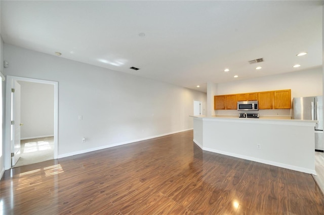 unfurnished living room with dark wood-type flooring