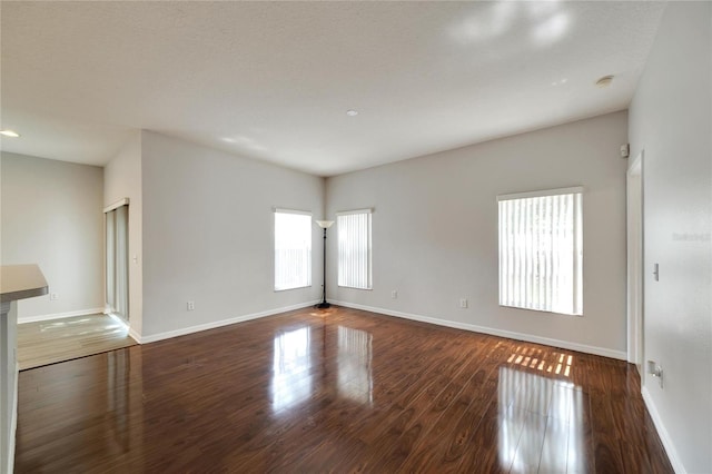 empty room featuring dark hardwood / wood-style flooring