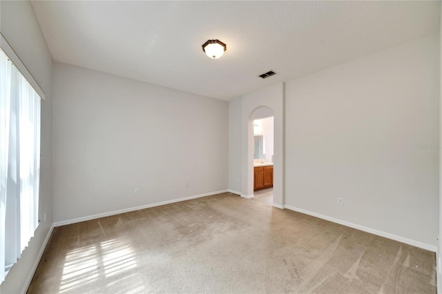 unfurnished room with light carpet