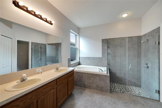 bathroom featuring plus walk in shower, vanity, and tile patterned floors