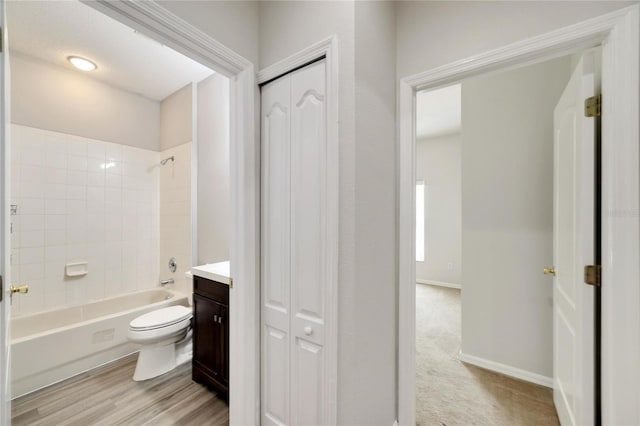 full bathroom featuring toilet, vanity, and tiled shower / bath