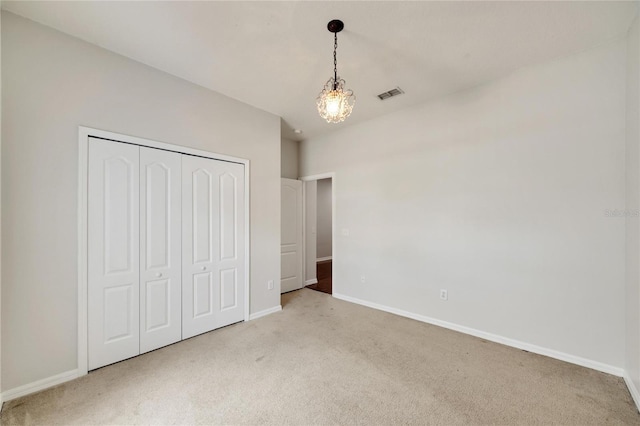 unfurnished bedroom with a closet and carpet floors