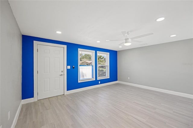 foyer entrance with ceiling fan and light wood-type flooring