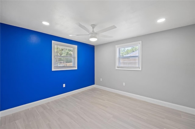 unfurnished room with light hardwood / wood-style floors, a wealth of natural light, and ceiling fan