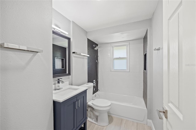 full bathroom with vanity, tiled shower / bath combo, and toilet