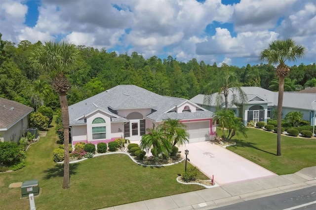 view of front of home featuring stucco siding, a shingled roof, concrete driveway, a front yard, and a garage