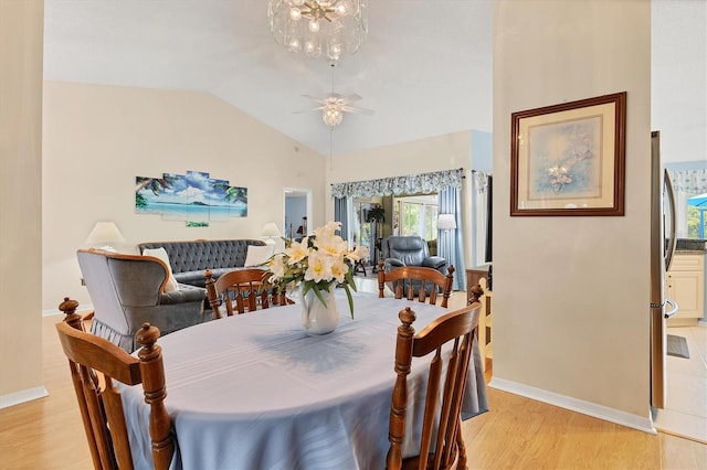 dining area featuring vaulted ceiling, light wood-type flooring, and ceiling fan