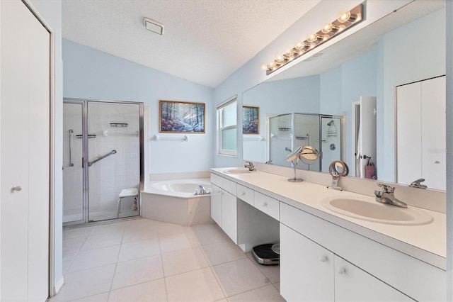 bathroom featuring vaulted ceiling, tile patterned flooring, a textured ceiling, shower with separate bathtub, and dual bowl vanity