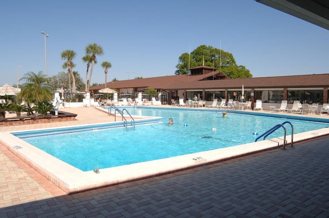 community pool with a patio area