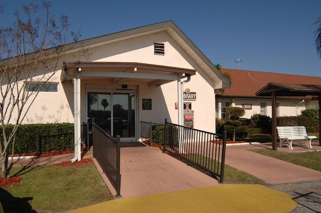 exterior space featuring fence and stucco siding