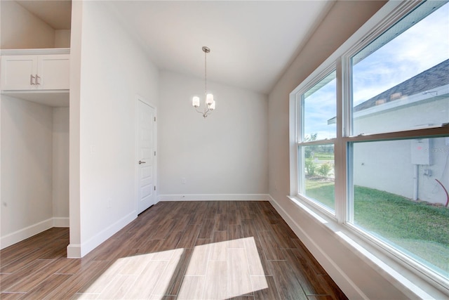 unfurnished dining area with plenty of natural light, lofted ceiling, and a chandelier