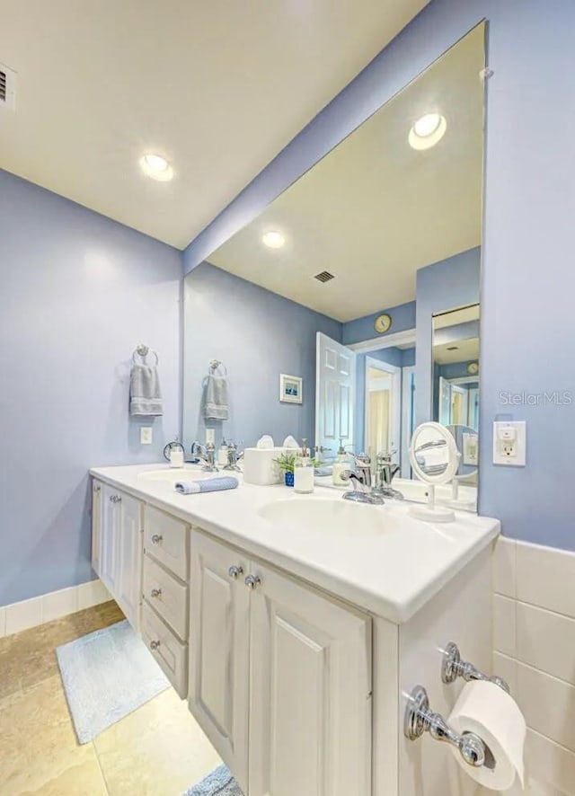 bathroom with tile patterned flooring and vanity