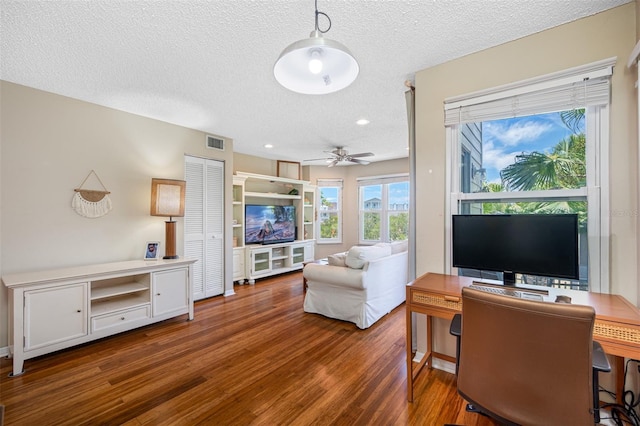 office area featuring dark wood-type flooring, a textured ceiling, and ceiling fan