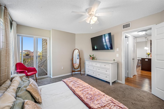 carpeted bedroom with a textured ceiling, ceiling fan, and access to outside