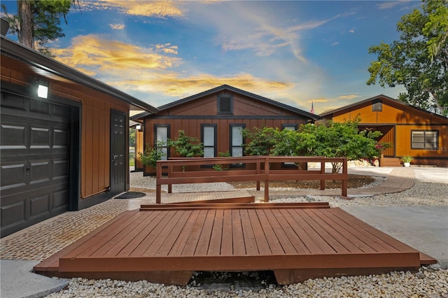 back house at dusk with a garage