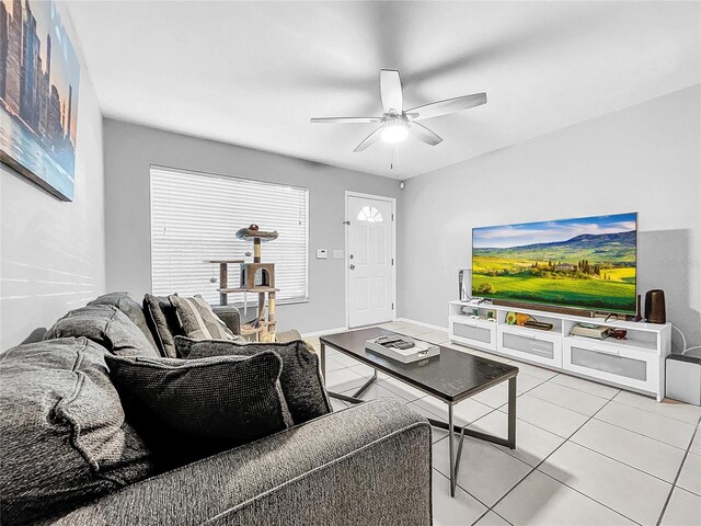 tiled living room with ceiling fan