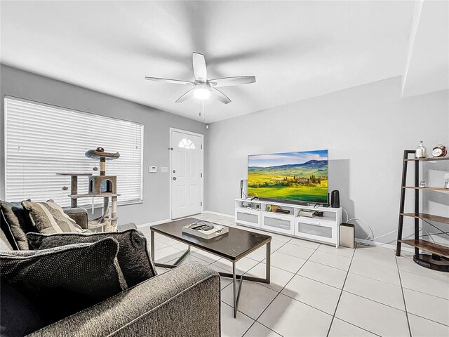 tiled living room with ceiling fan