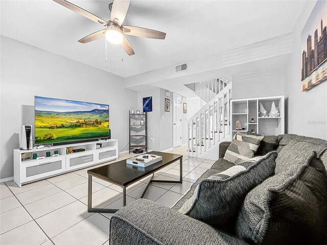 tiled living room with ceiling fan