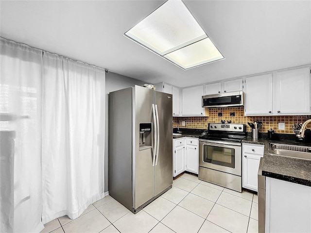 kitchen featuring white cabinets, sink, decorative backsplash, and appliances with stainless steel finishes