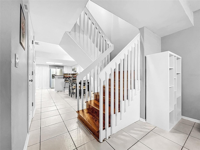 stairway featuring tile patterned floors