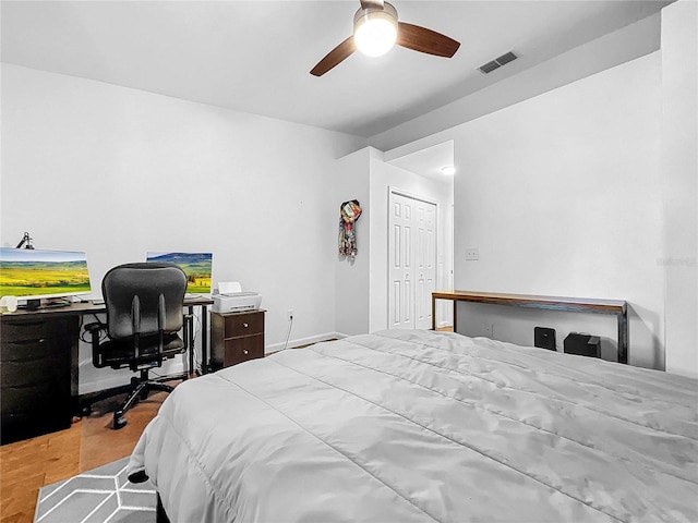 bedroom featuring ceiling fan, a closet, and light hardwood / wood-style flooring