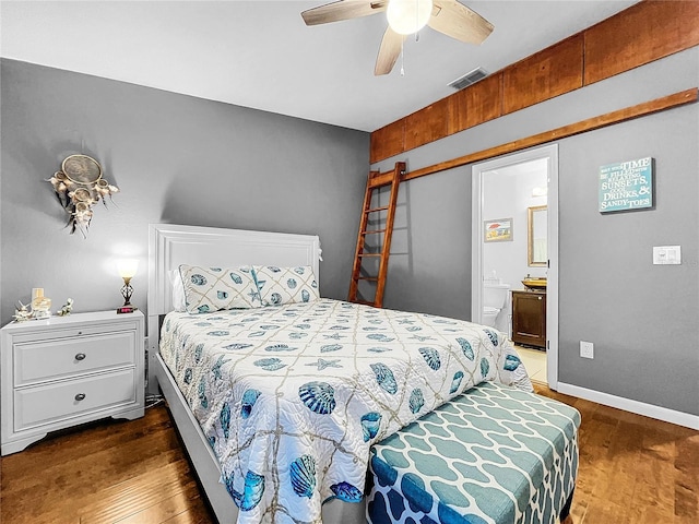 bedroom featuring ceiling fan, connected bathroom, and dark hardwood / wood-style flooring