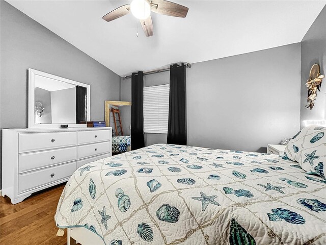 bedroom with hardwood / wood-style flooring, ceiling fan, and lofted ceiling