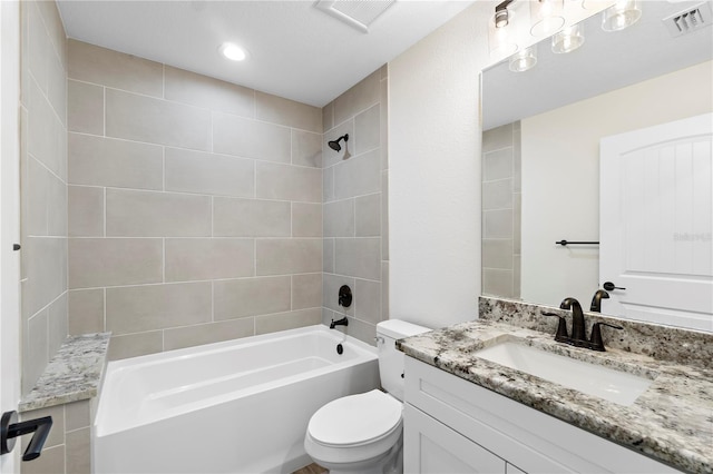 full bathroom featuring toilet, vanity, and tiled shower / bath