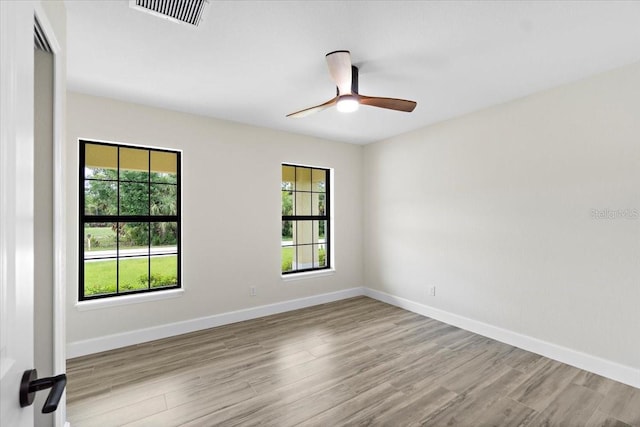 spare room with ceiling fan and light hardwood / wood-style floors