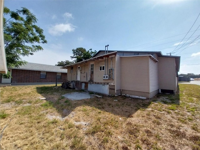 back of house featuring a patio area and a yard