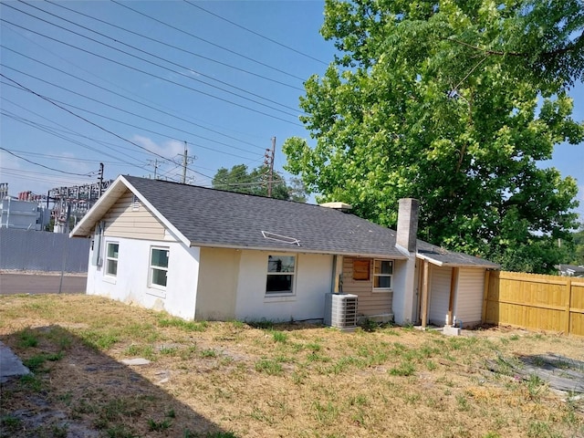 back of house featuring central AC unit