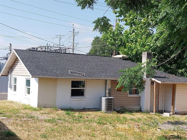 back of property featuring a yard and central AC unit