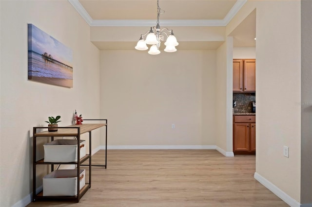 hallway featuring crown molding, a chandelier, and light hardwood / wood-style flooring