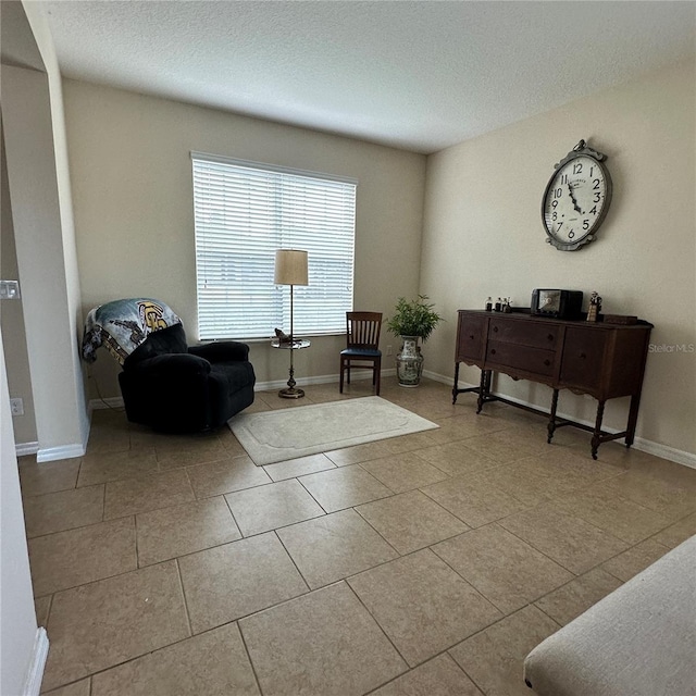 living area featuring light tile patterned floors and a textured ceiling