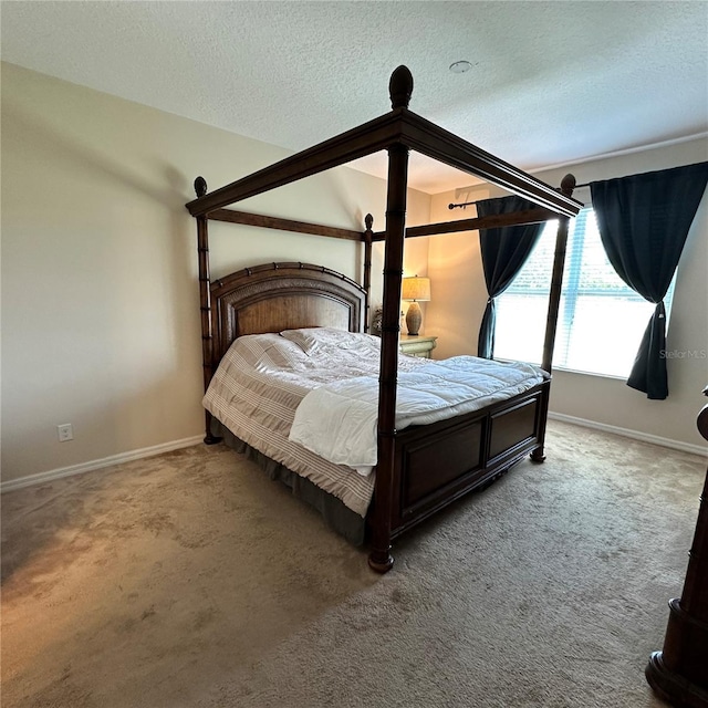 carpeted bedroom with a textured ceiling