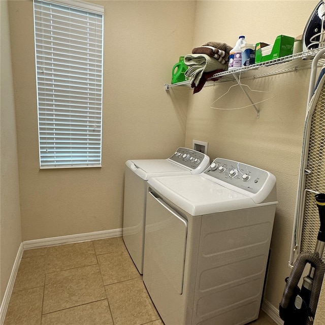 laundry room with light tile patterned floors and washing machine and dryer