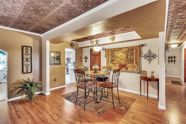 dining room featuring hardwood / wood-style flooring and ornamental molding