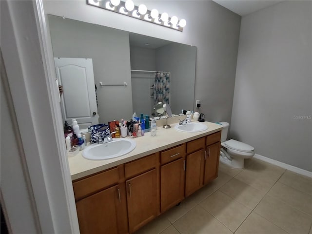 bathroom featuring tile patterned flooring, vanity, curtained shower, and toilet