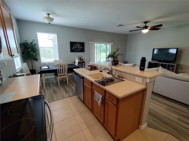 kitchen featuring dishwasher, ceiling fan, plenty of natural light, and light tile patterned flooring