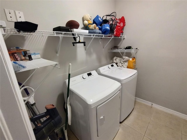 laundry area featuring light tile patterned floors and washer and dryer