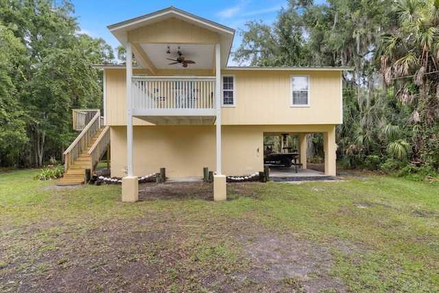 rear view of house featuring a patio, ceiling fan, and a yard