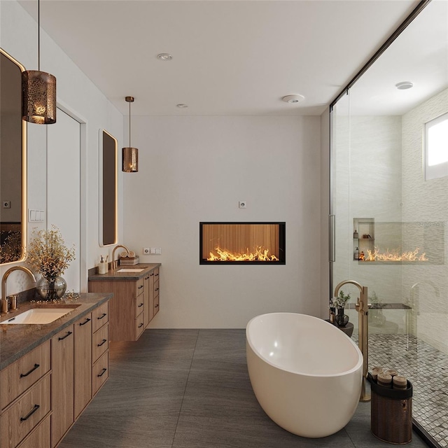 bathroom featuring tile patterned flooring, vanity, and shower with separate bathtub