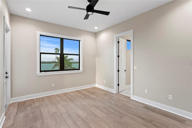 interior space featuring light wood-type flooring, baseboards, and recessed lighting