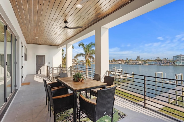 balcony featuring a water view and ceiling fan