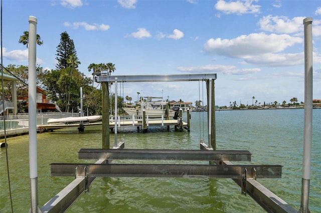 dock area with a water view and boat lift