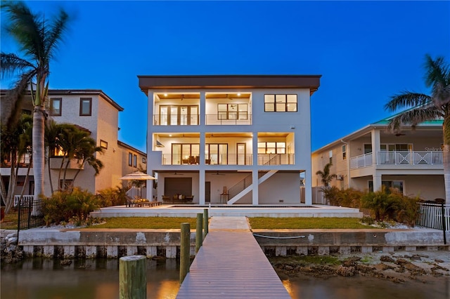 back of house featuring a patio area, fence, a balcony, and stucco siding